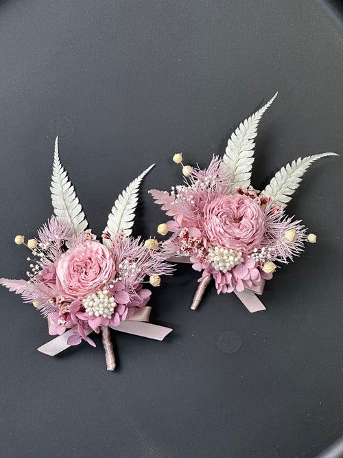Close-up of dusty pink preserved flower brooches with cream foliage; price is for one brooch.